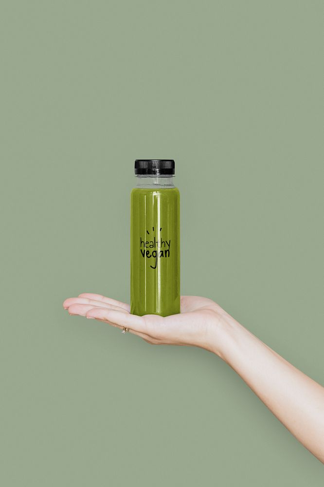 Woman holding a bottle of celery juice mockup