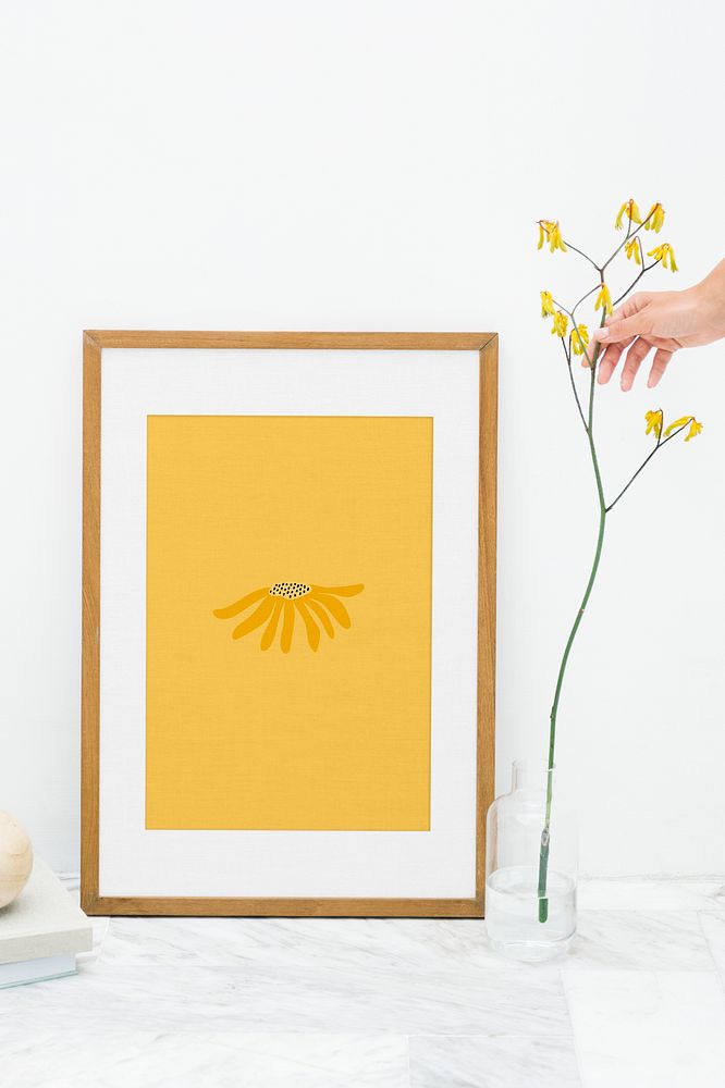 Photo frame mockup by a yellow forsythia