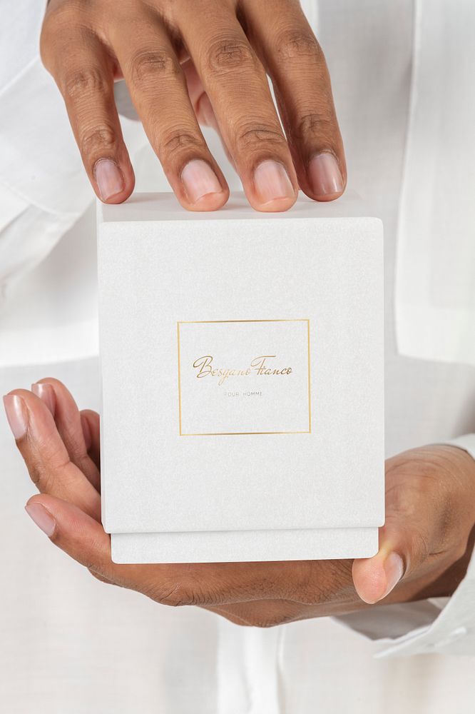 Hands holding a cosmetic packaging mockup
