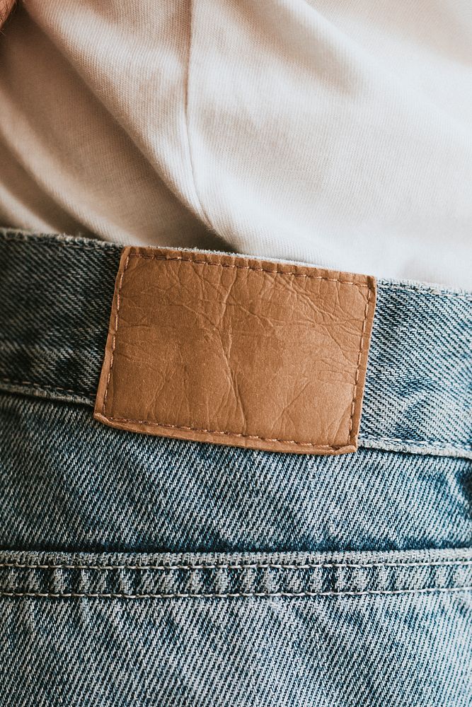 Leather clothing label mockup psd on washed men's jeans