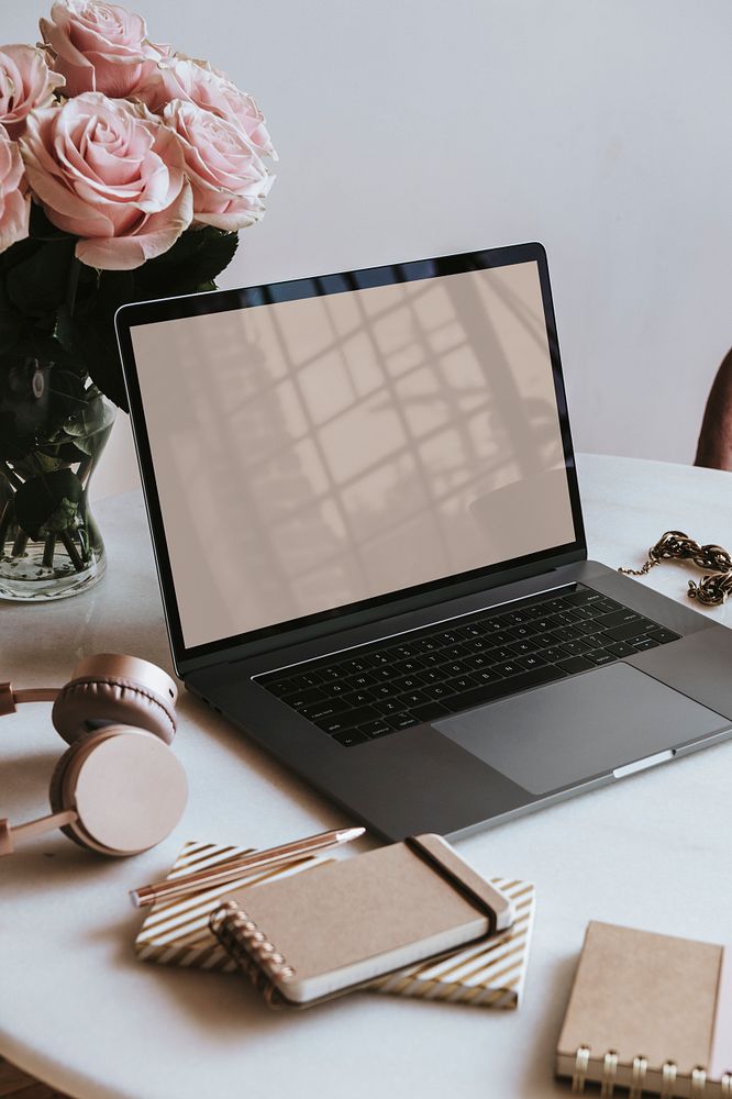 Fresh flowers by a laptop screen mockup