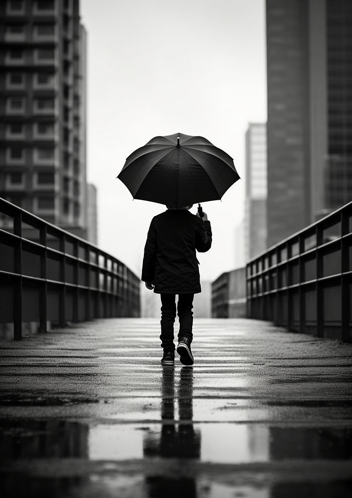A kid wearing black coat carry white unbrella photography walking rain. AI generated Image by rawpixel.