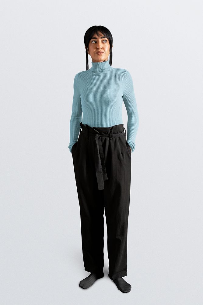 Mixed race woman wearing blue turtleneck sweater with black pants, autumn apparel fashion design