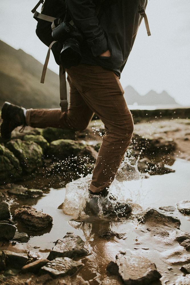 Hiker running through the water