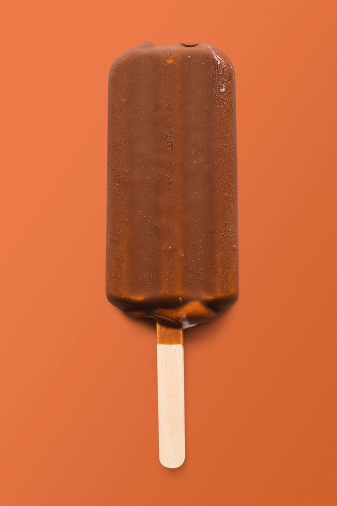 Chocolate glazed ice cream on orange background, food photography