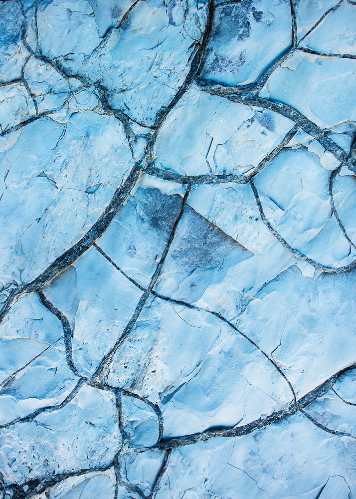 Cracked ground texture, blue background 