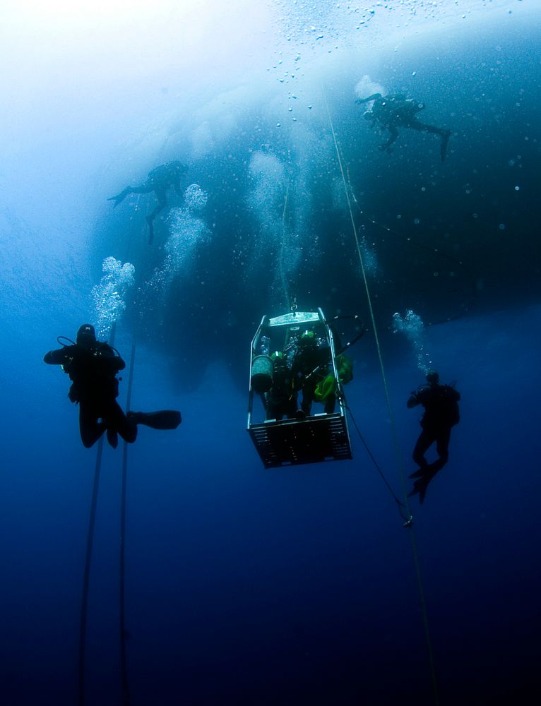 U.S. Navy divers, assigned to Company 4, Mobile Diving and Salvage Unit 2, and the Joint POW/MIA Accounting Command (JPAC)…