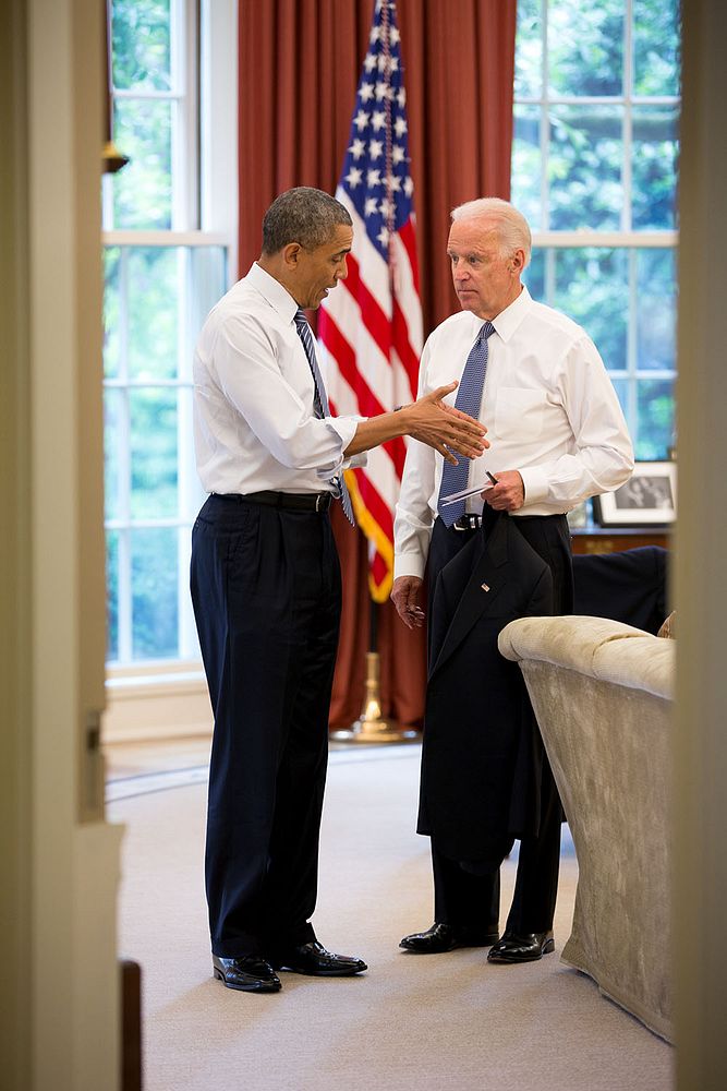 President Barack Obama talks with Vice President Joe Biden in the Oval Office after their lunch together, May 30, 2014.