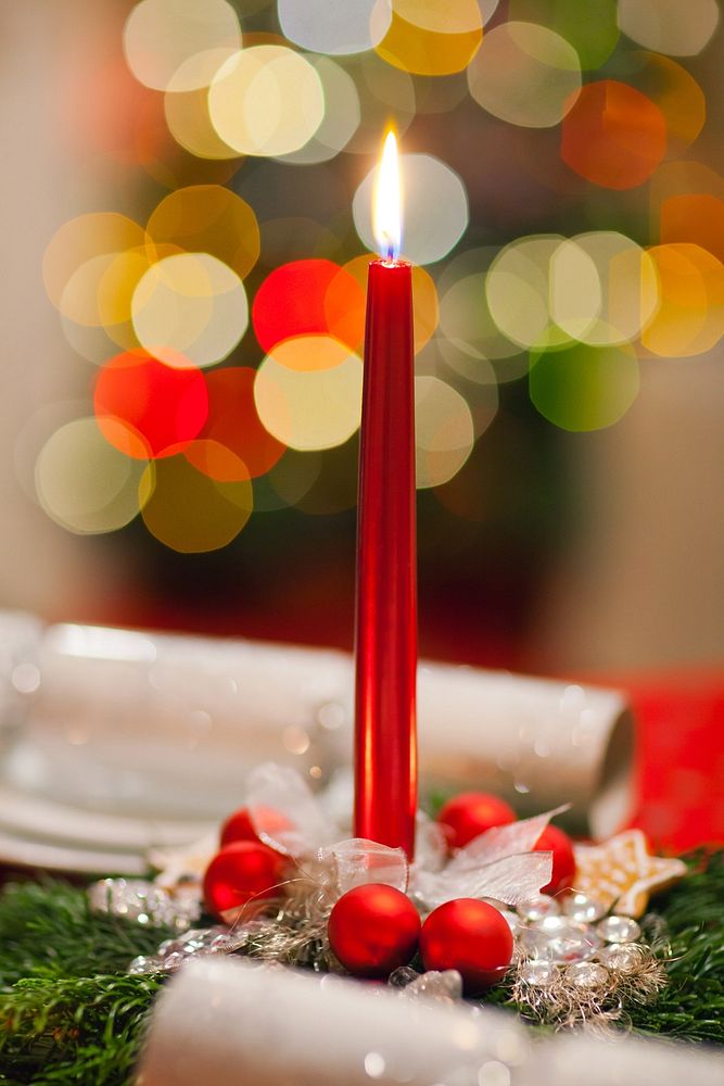 Burning Christmas candle on dinner table. Free public domain CC0 photo.