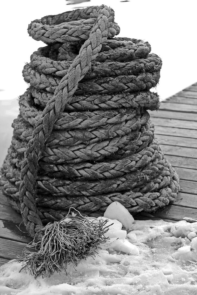 Wrapped rope on wooden dock. Free public domain CC0 image.