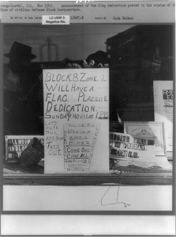 Chicago (north), Illinois. Announcement of the flag dedication posted in the window of the Office of the Civilian Defense…