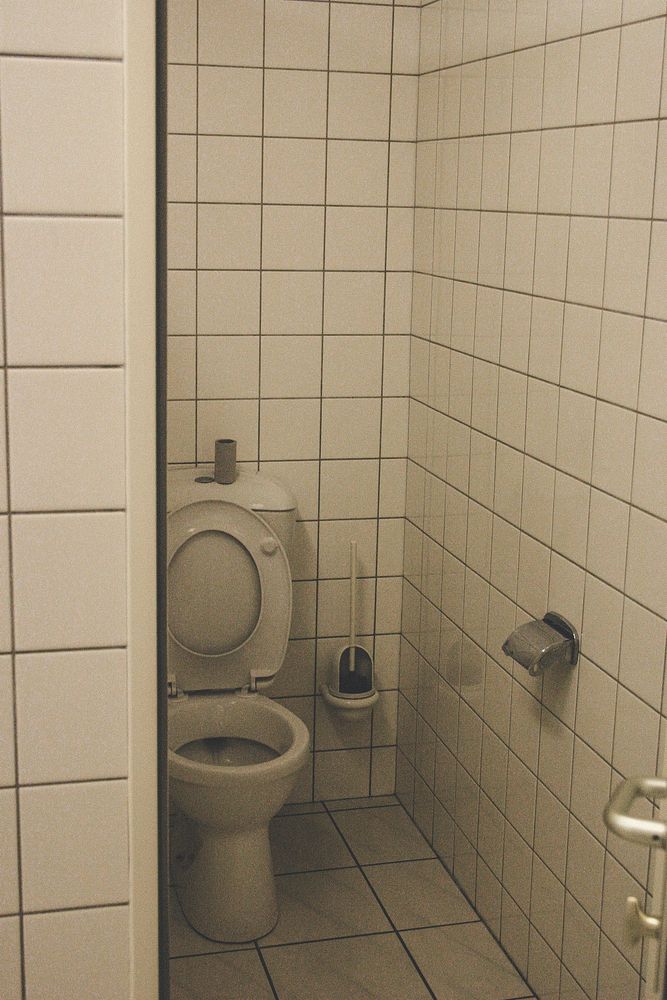 Toilet with white tiles all over