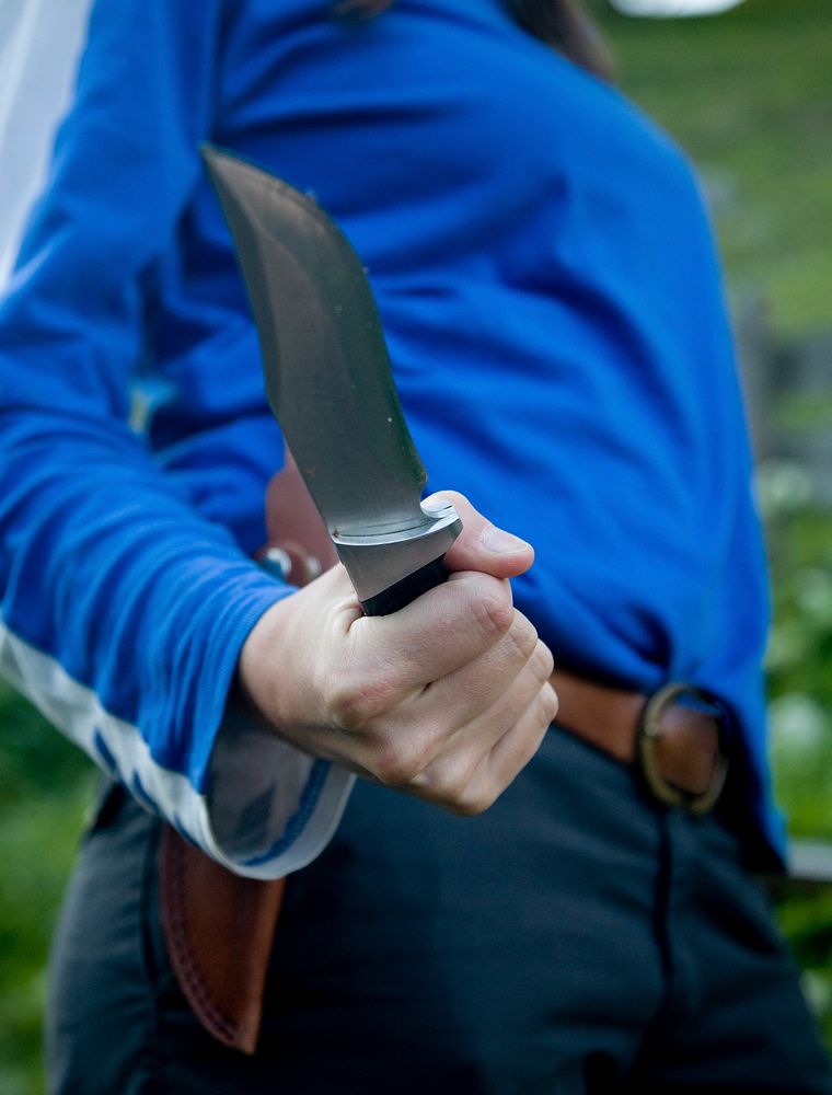 Close up of an adult holding a knife