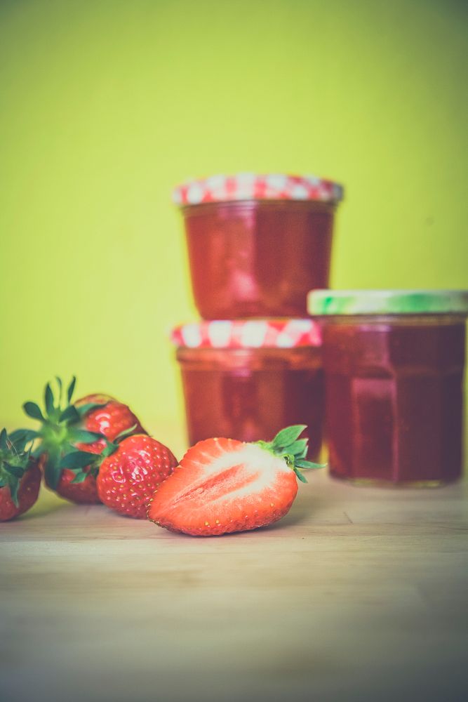 Strawberry jam and marmalade on wooden table