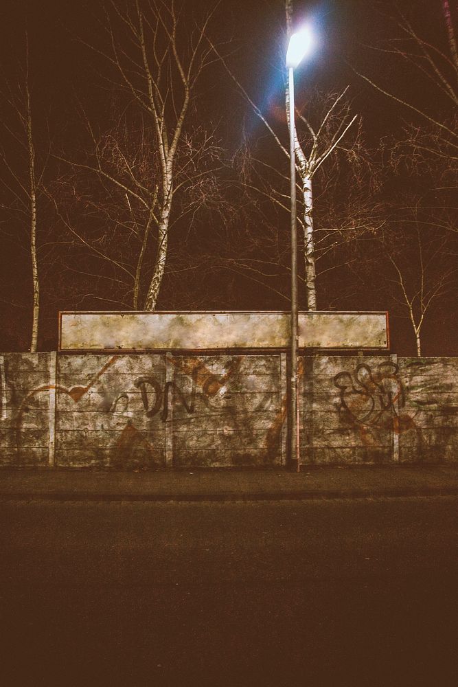Graffiti on a street wall at night