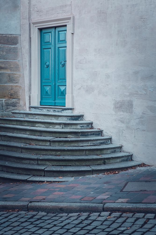 Blue door atop a small staircase