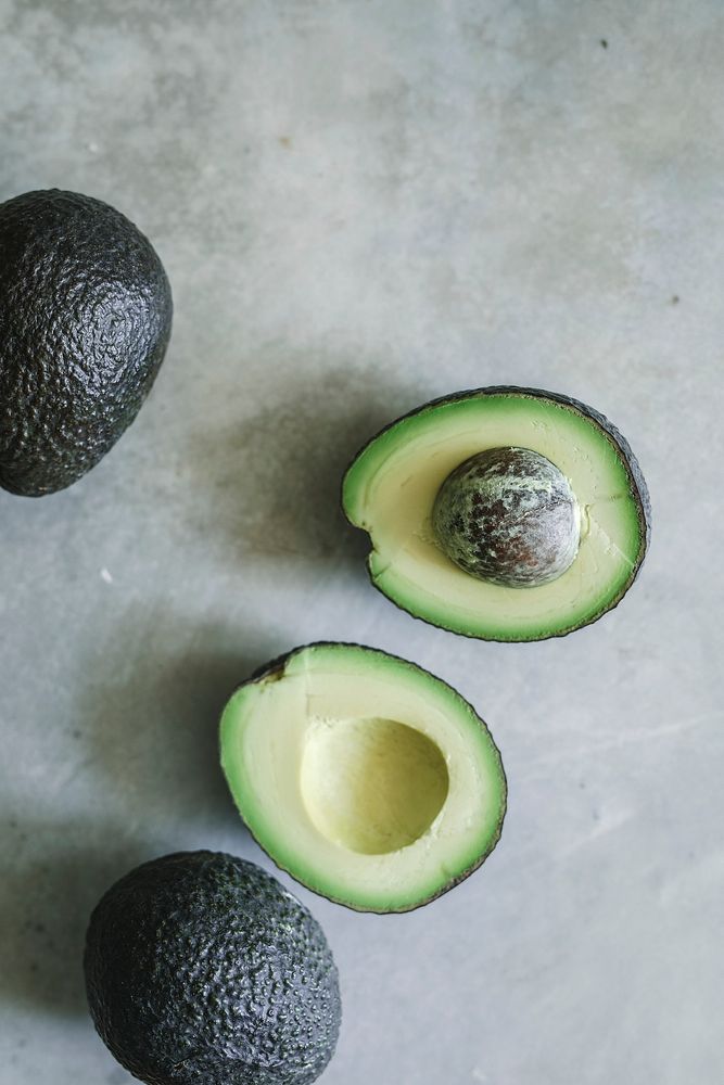 Fresh avocados on a gray background