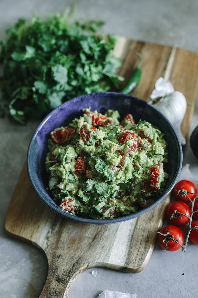 Homemade guacamole with cherry tomatoes food photography recipe idea