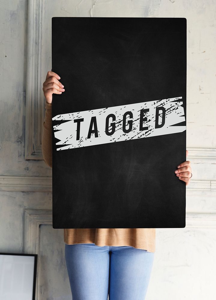 Woman holding tagged board