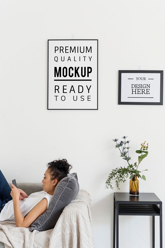 Woman relaxing with mockup frames hanging on the wall