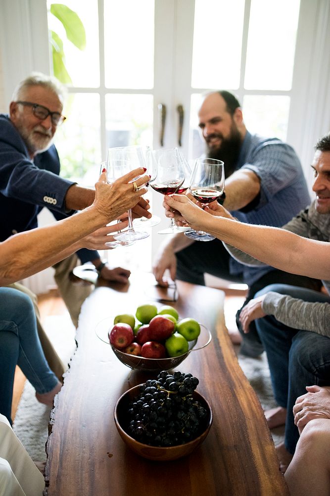 People are celebrating together with glasses of wine