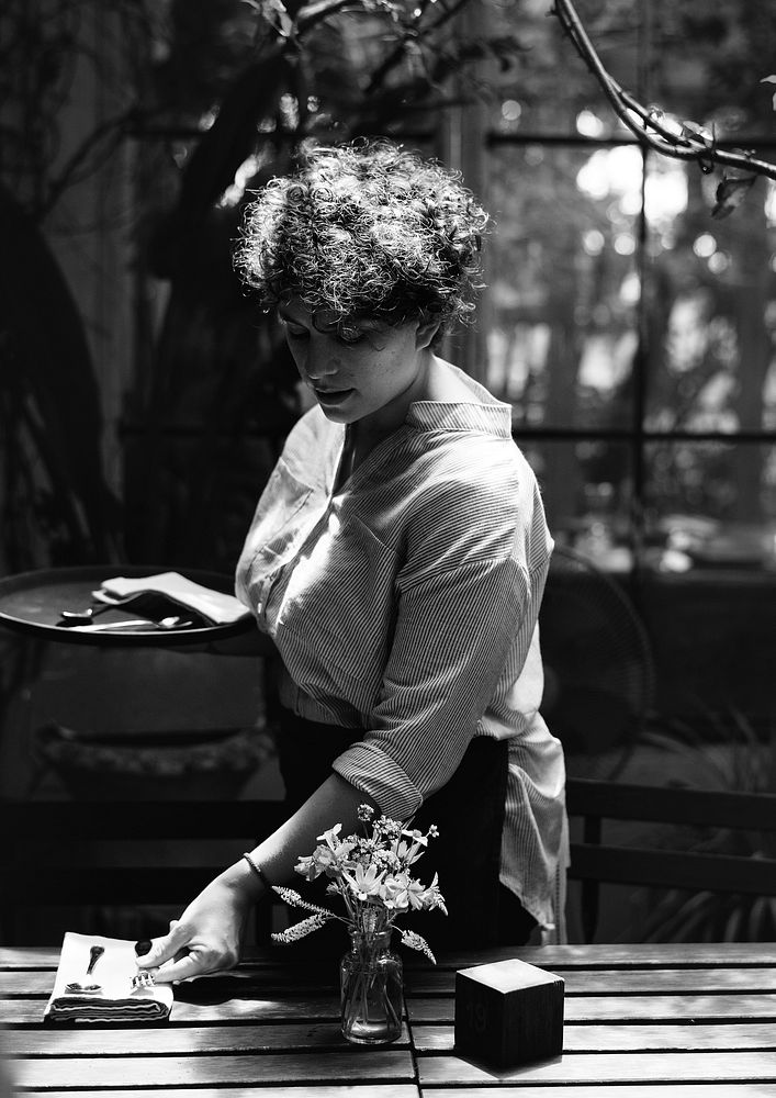 Black and white portrait of a woman working in a cafe
