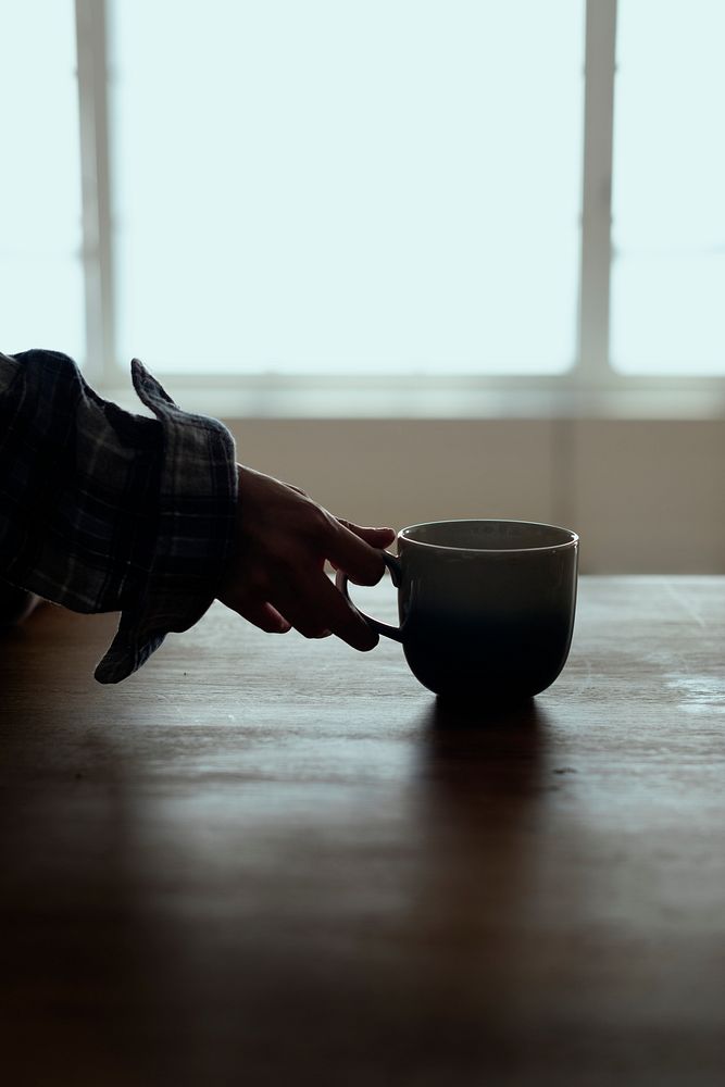 Hand holding a cup of coffee