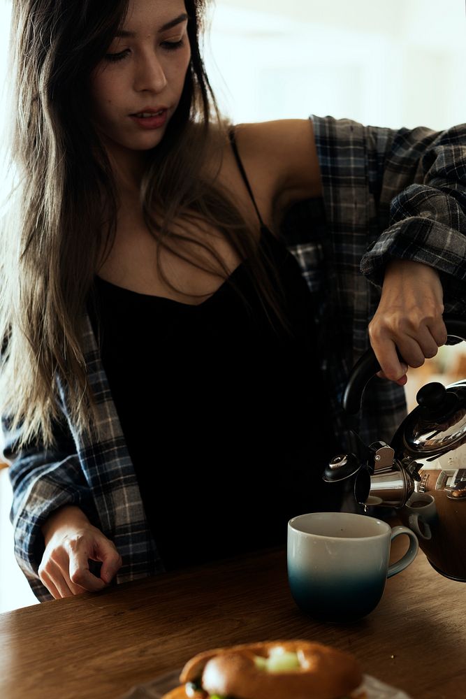Young woman pouring a coffee