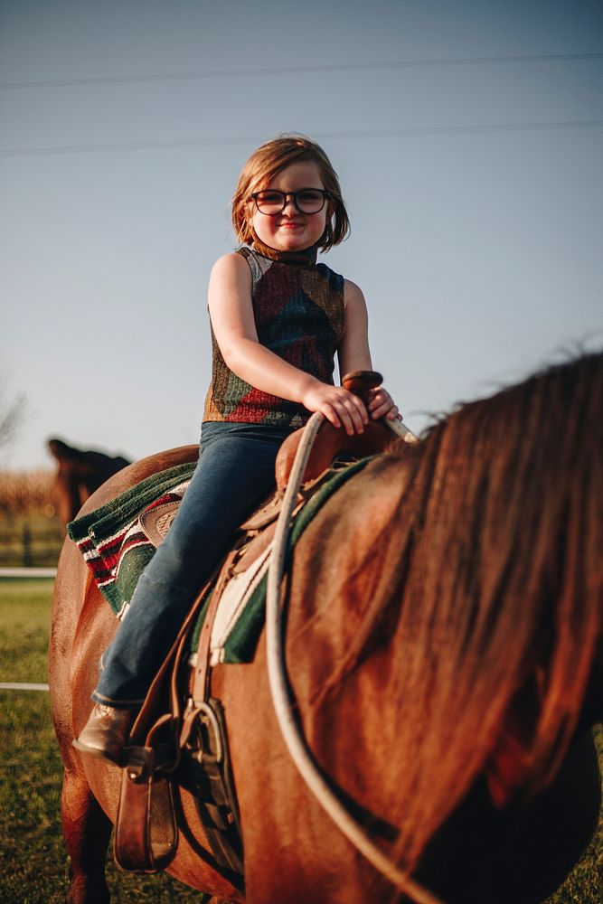 Young girl is enjoying a horse riding