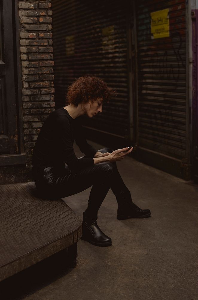 Woman waiting with mobile phone in hand