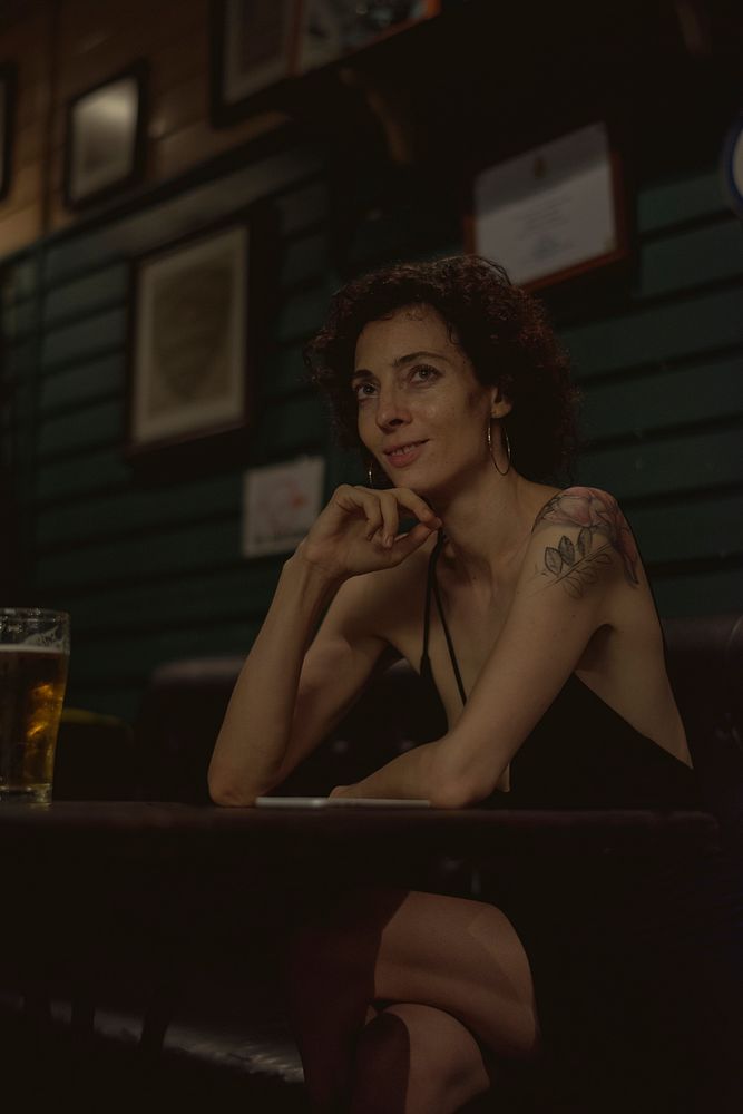 Portrait of a lone woman at a bar