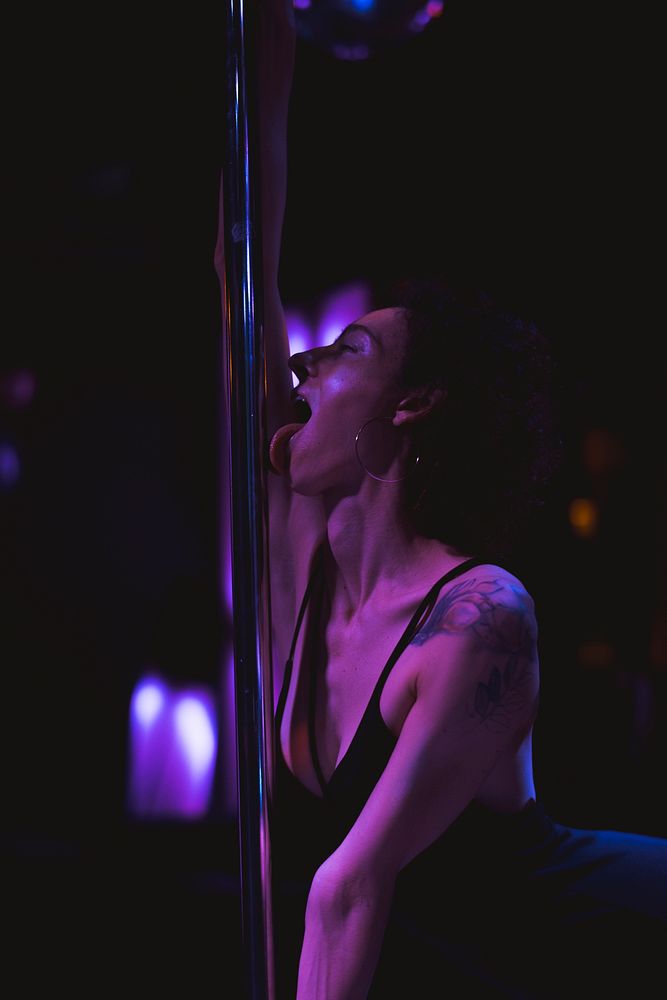Woman having fun with a stripper pole