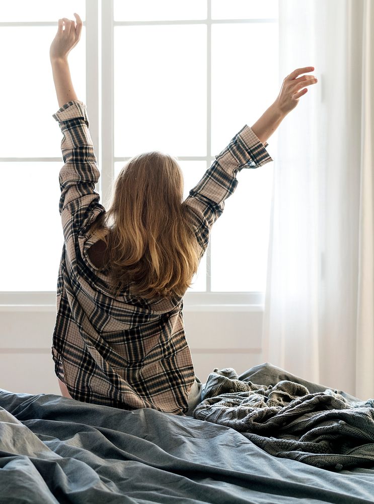 Rear view of woman stretching her arms in the morning