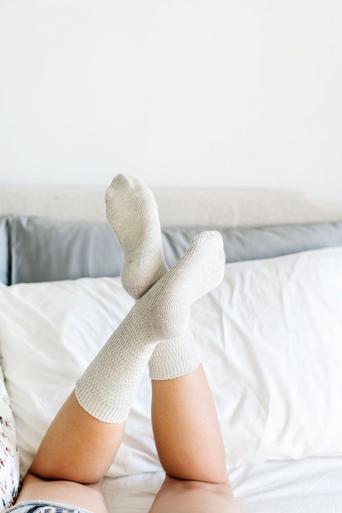 Closeup of woman legs on bed