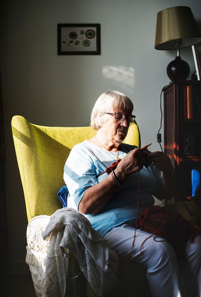 Senior woman knitting at home