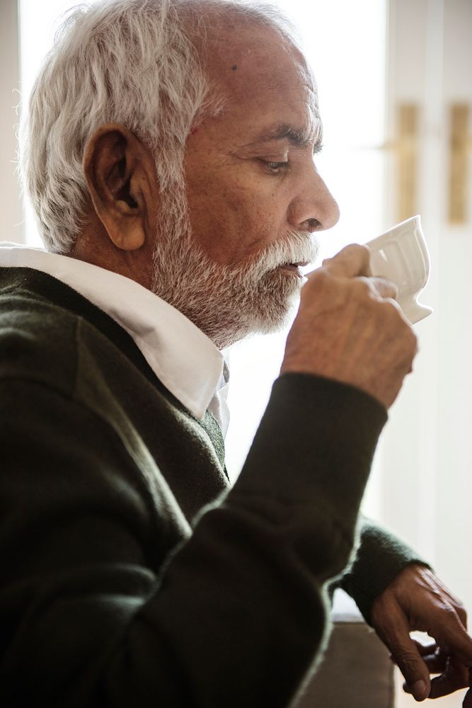 Senior man sipping and drinking tea