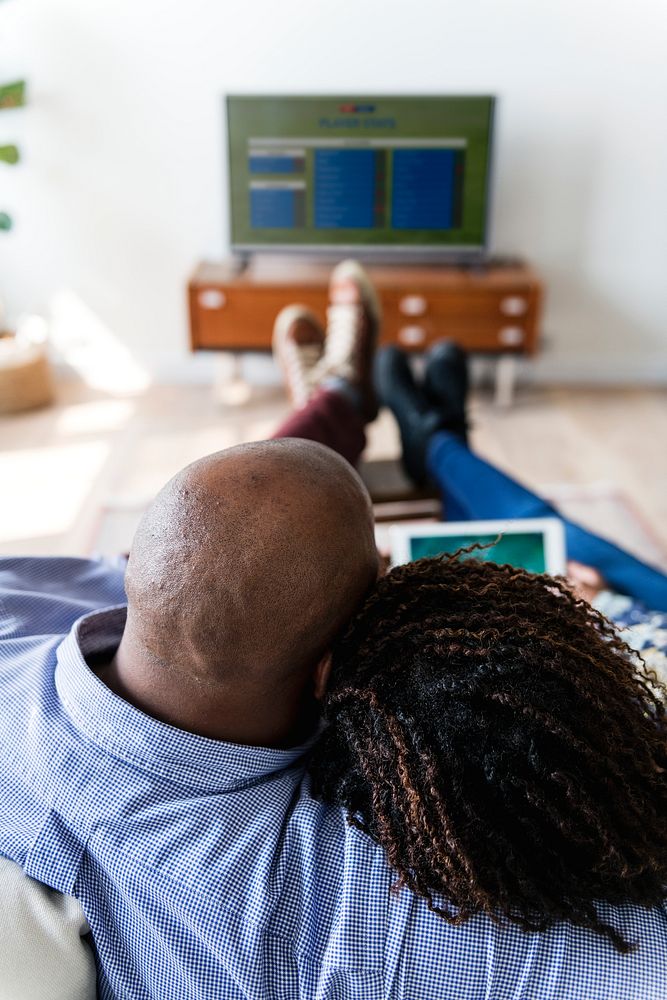 Couple watching TV at home together