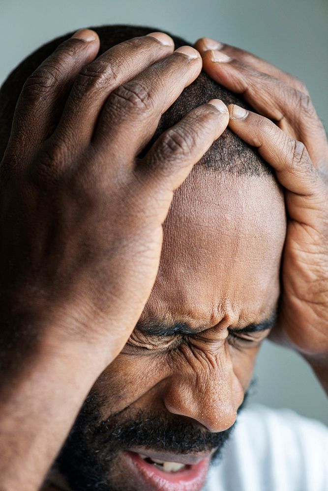 Black man suffering from migraine
