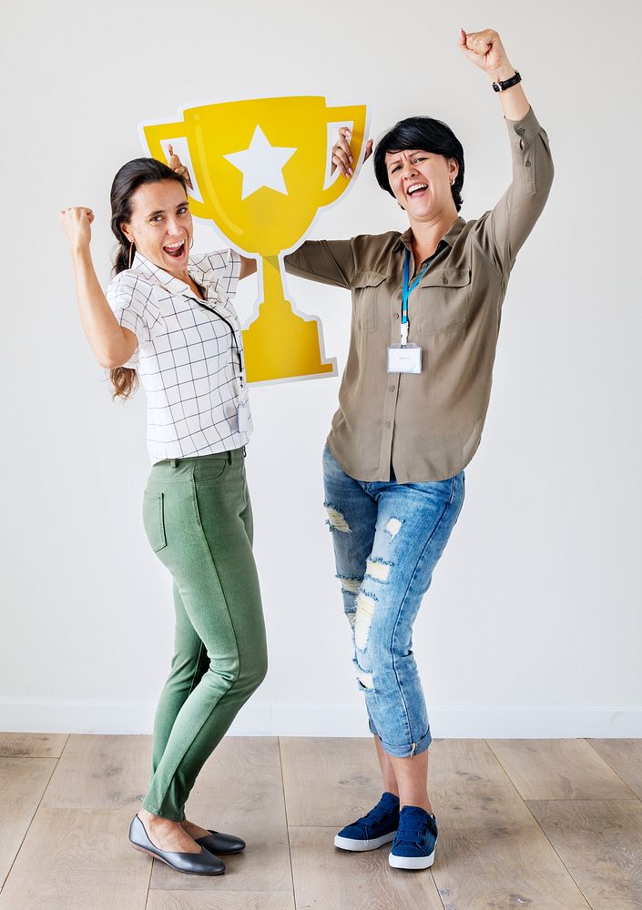 Women celebrating their success with a trophy