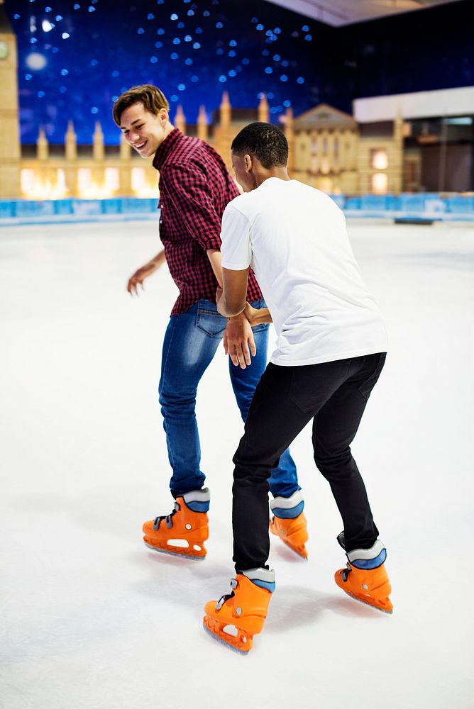 Friend teaching a friend how to ice skate friendship and leisure concept