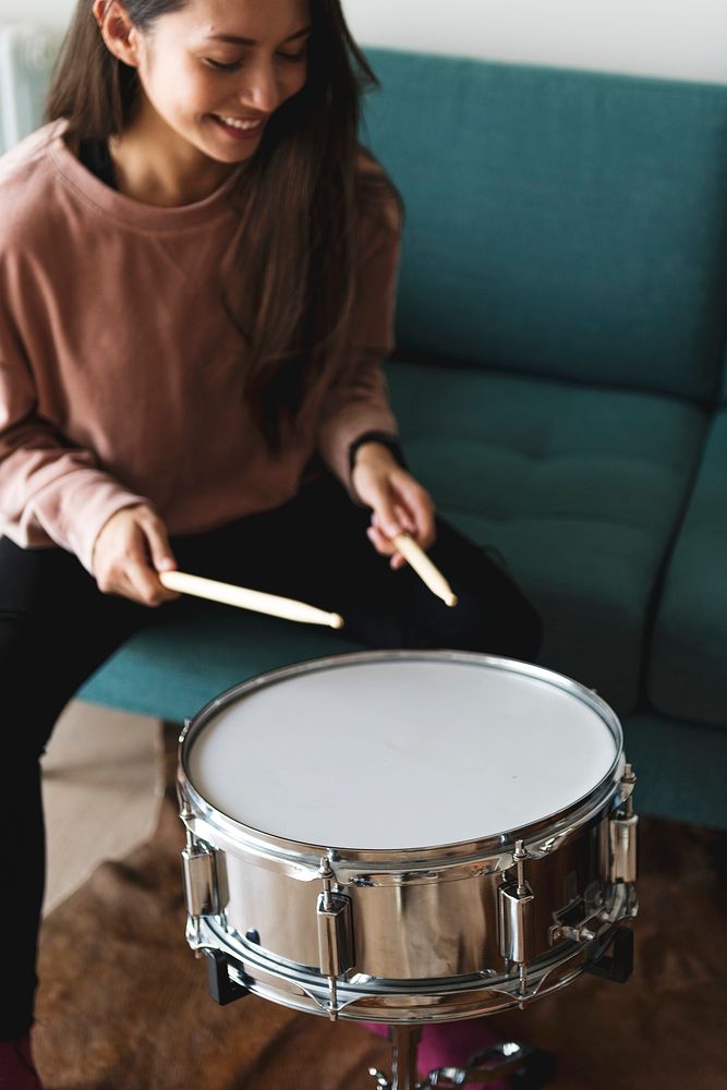 White woman playing drum