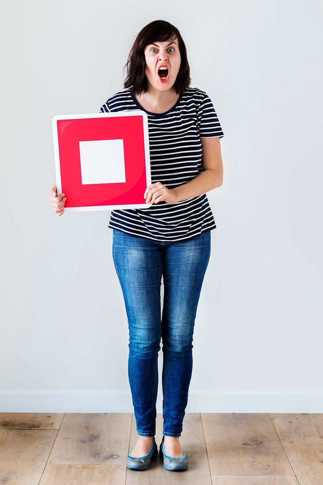 Caucasian woman holding a red stop icon