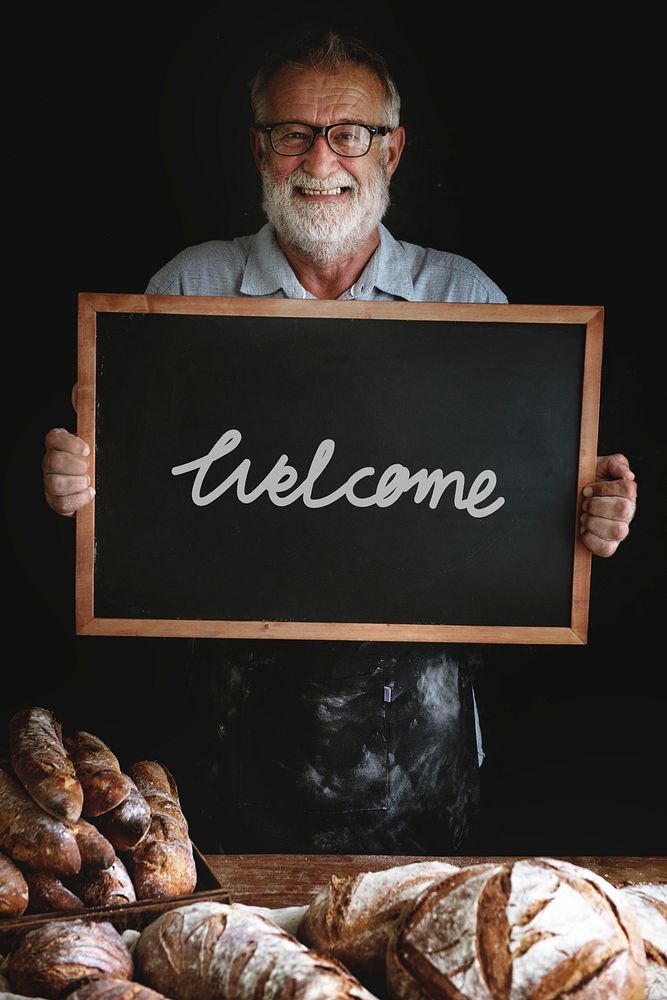 Baker holding a welcome sign