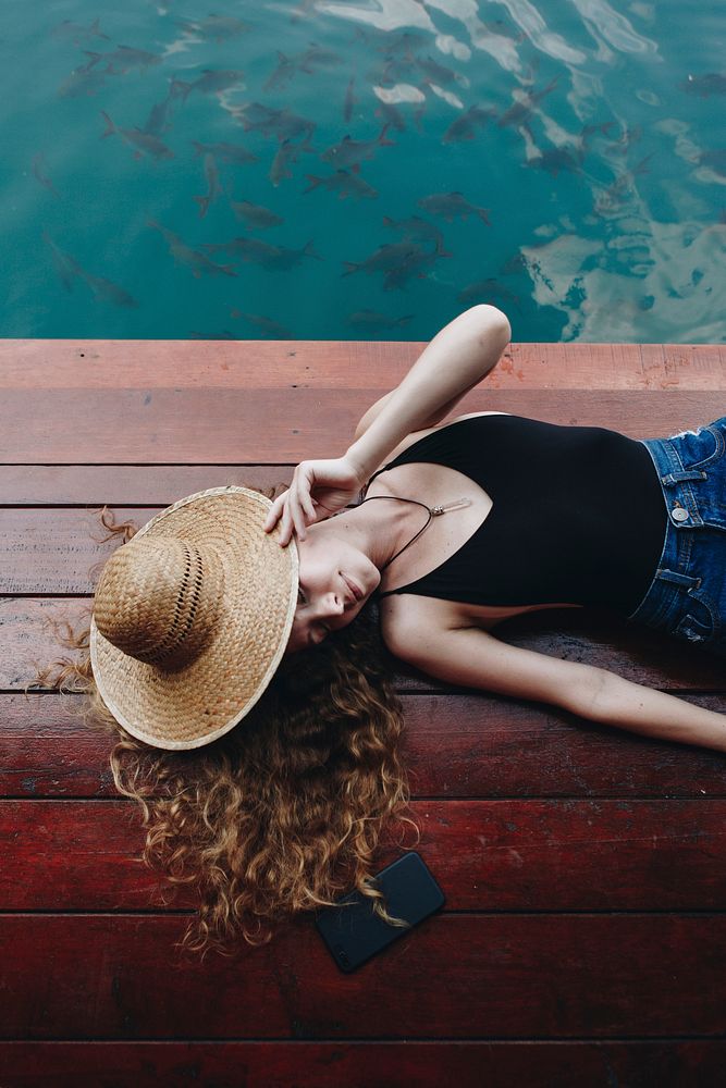 Woman relaxing on a wooden jetty