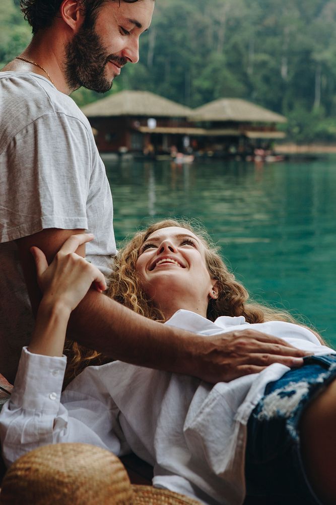 Woman relaxing in her boyfriends lap