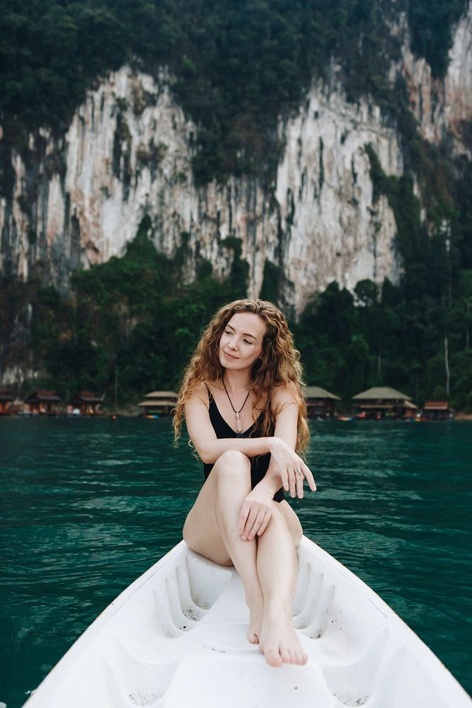 Woman relaxing on a canoe at a lake