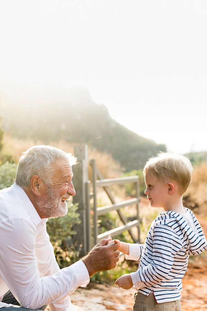 Granddad and grandson at a countryside farm blank space 