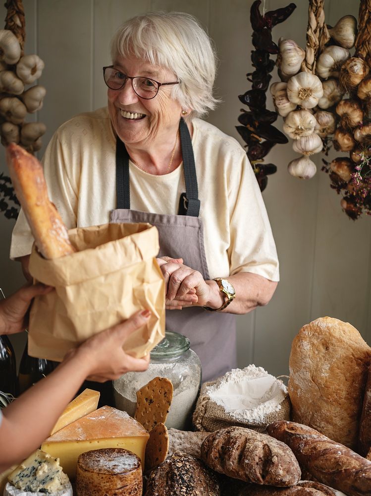 Elderly woman selling bread at a deli