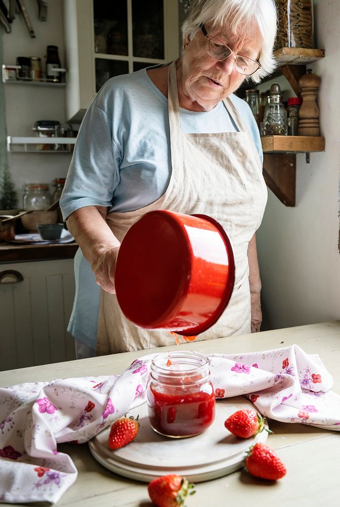 Old woman making homemade jam