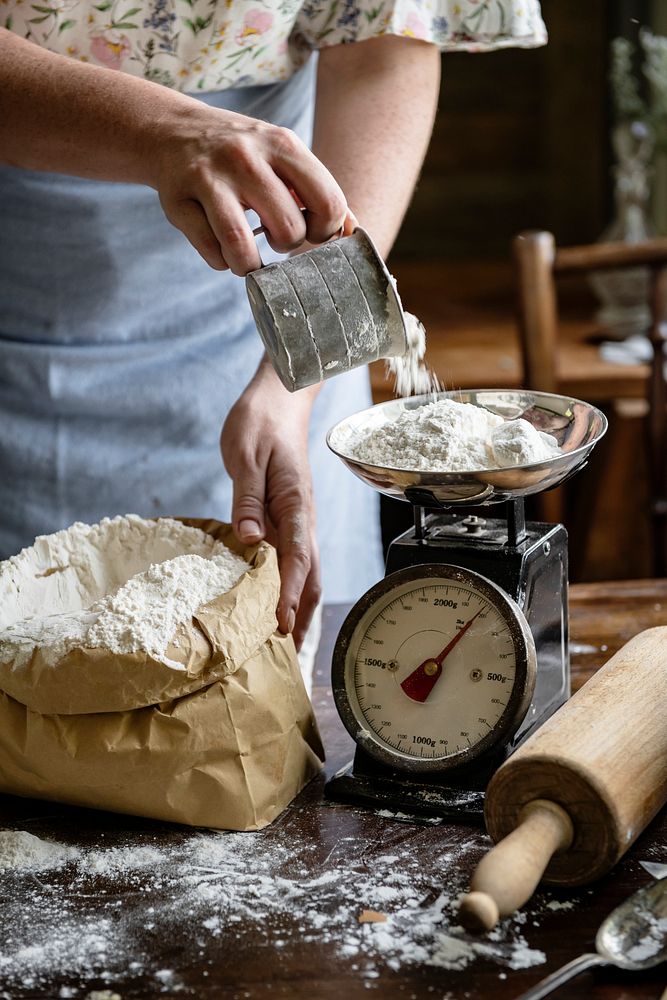 Woman weighing flour on a scale